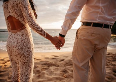 Nhu and her husband holding hands on a beach
