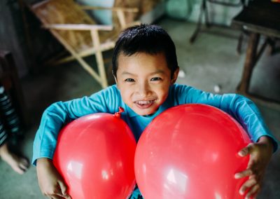 A Boy with two red balloons