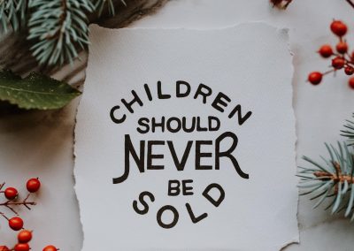 A sign that reads "Children Should Never Be Sold"