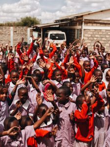 A Group of children waving their hands