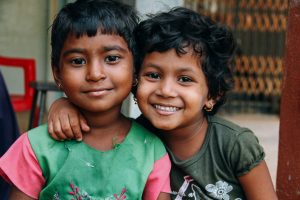 Two young children smiling together.