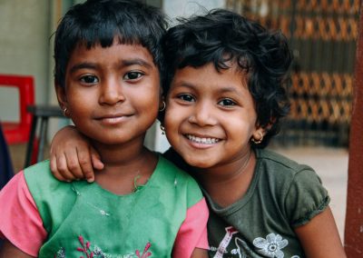 Two young children smiling together.