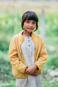 A girl standing in a field.