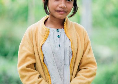 A girl standing in a field.