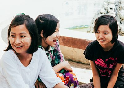 Three girls smiling together.