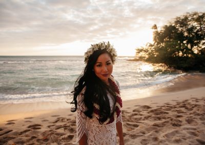 Nhu wearing a wedding dress while on a beach.