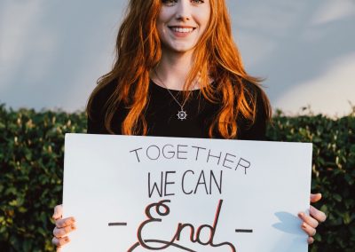 A Girl Holding a sign that says "Together We Can End Child Sex Slavery"