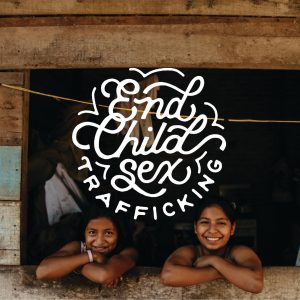 Two girls smiling next to text that reads "End Child Sex Trafficking"