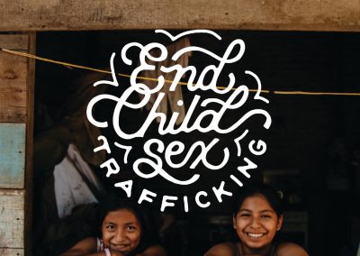 Two girls smiling next to text that reads "End Child Sex Trafficking"