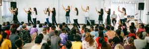 People dancing infront of a crowd